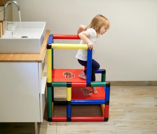 Girl climbing from learning tower