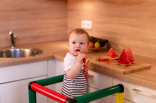 Child with melon on learning tower