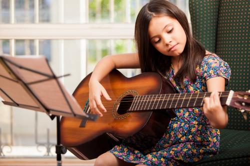 A girl playing the guitar
